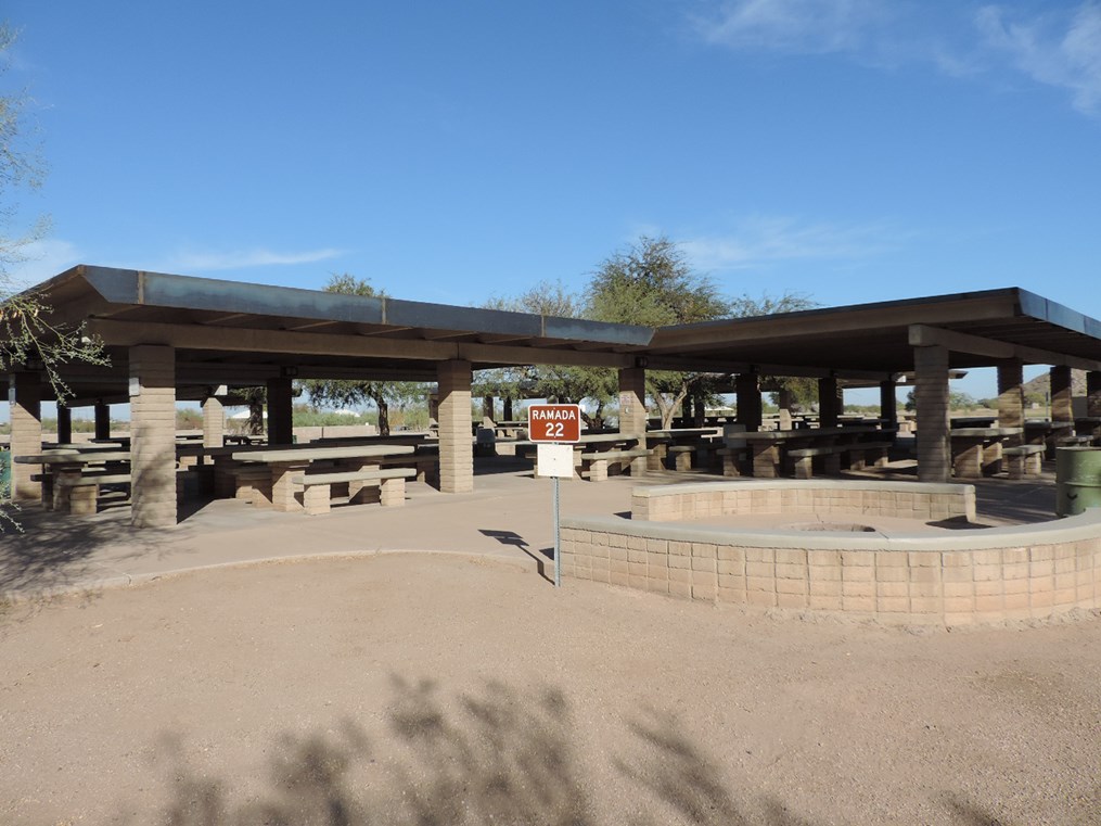 Ramada 22 large covered picnic complex with multiple tables on a cement slab and accessible walkway.
