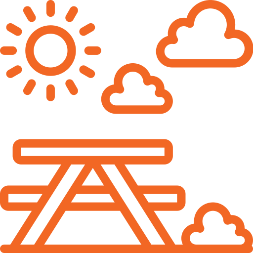 An orange picnic icon showing a picnic table with sun and clouds overhead.